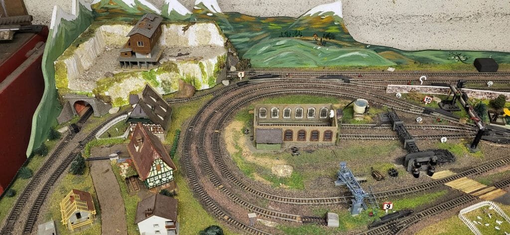Maquette de train miniature avec gare et paysage montagneux